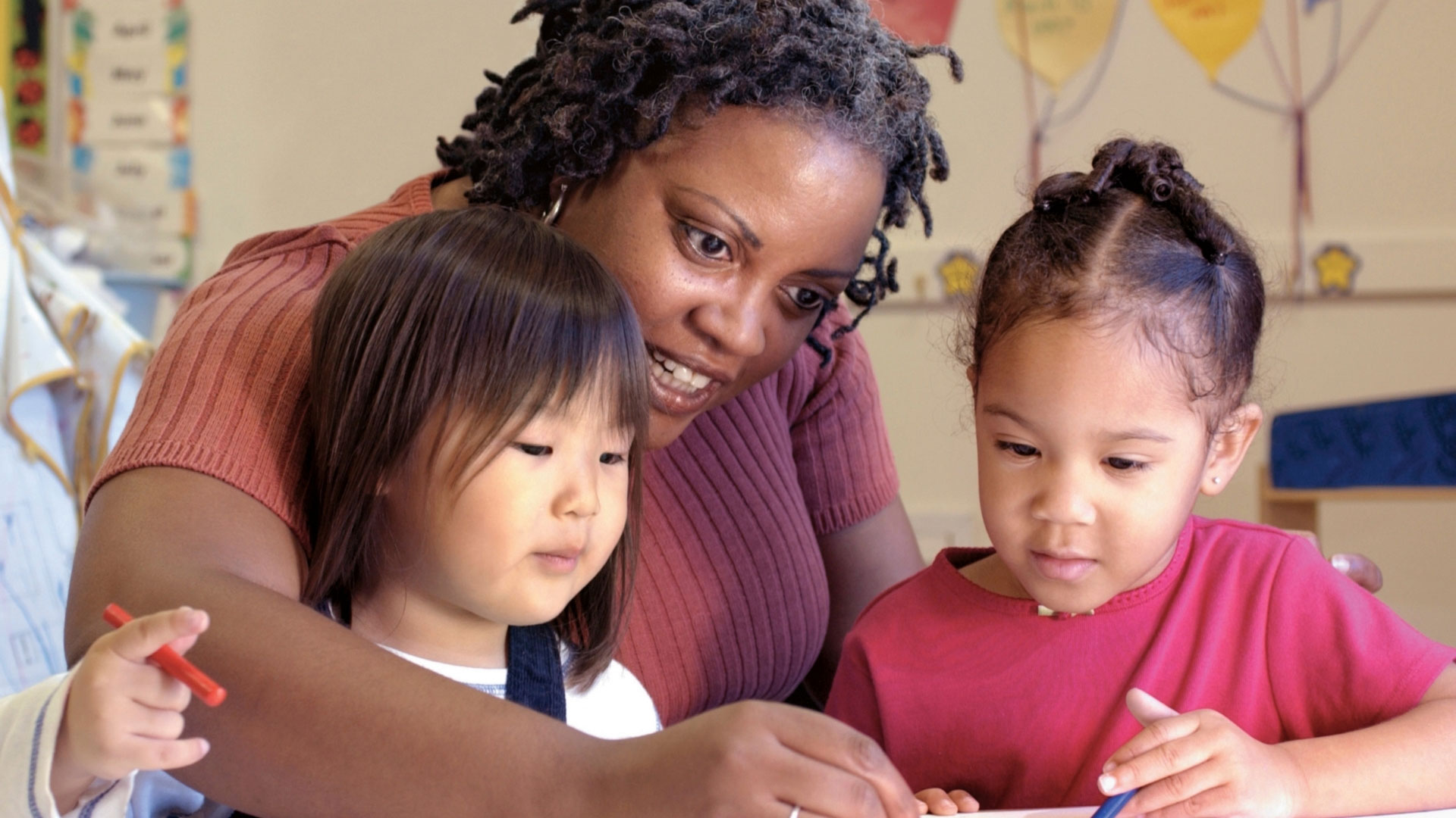 a child care provider with two young girls