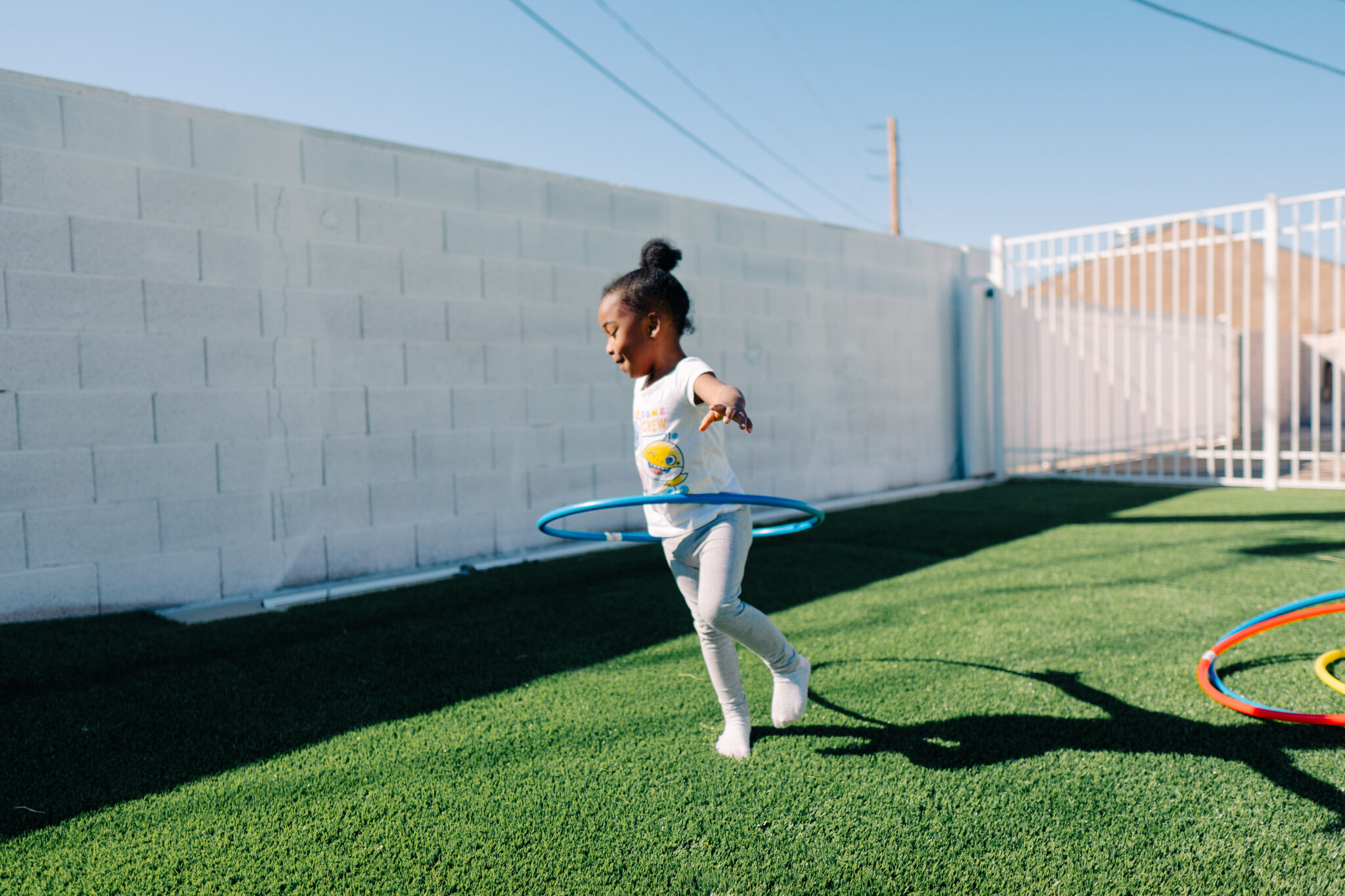 A little girl playing in the backyard of a Las Vegas home acquired by Care Access Real Estate