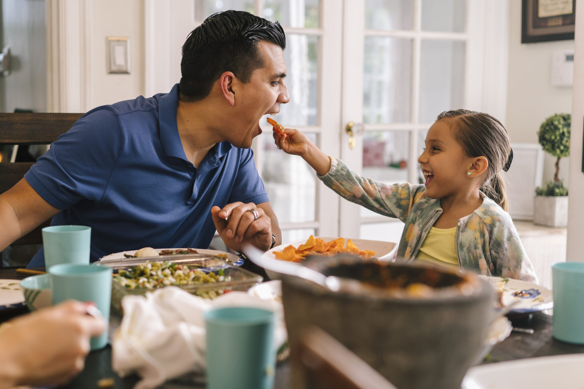 father and daughter at the dinner table