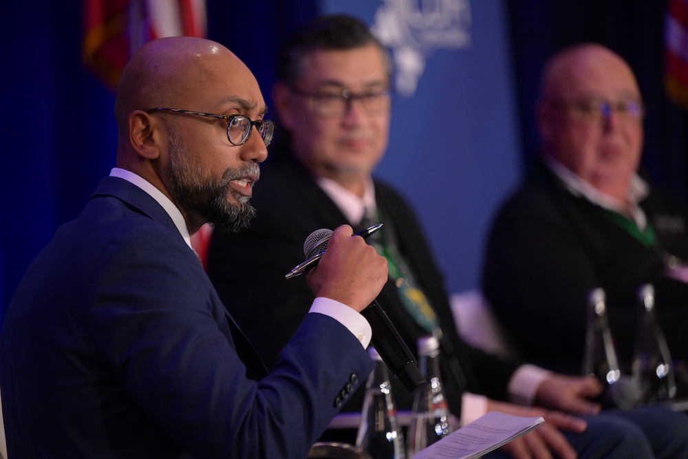 Three people speak on a panel